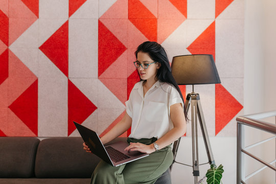 Young business woman working in a co-working environment