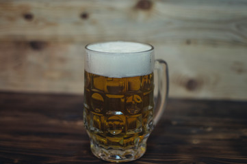 mug of light beer on a wooden background