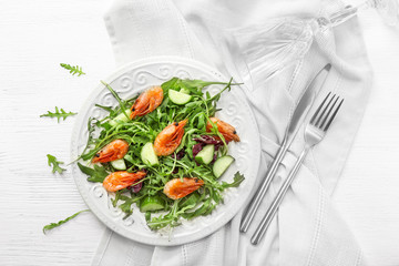 Plate with tasty shrimp salad on white table