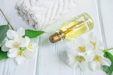 Photo of jasmine oil. Jasmine flowers and oil. Photo cosmetology and spa