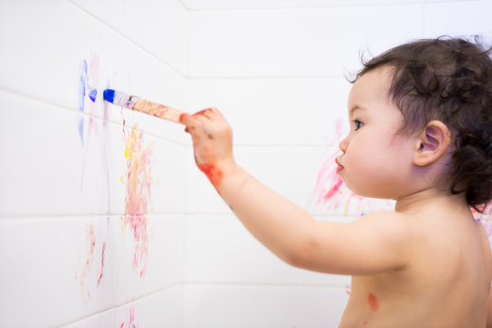 Young painter - toddler with bathroom walls