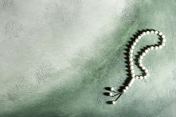 Muslim beads on color background