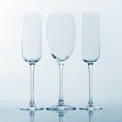 three empty wine glass on a light background. tableware for drinks.