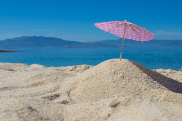 parasol in the sand of the beach, summer and holidays