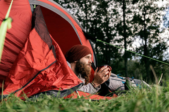 Young man using mobile in the woods