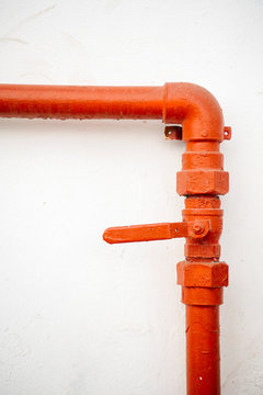 Orange colored pipe against wall