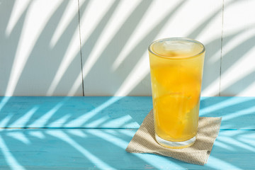 orange water with fresh fruit on colorful background