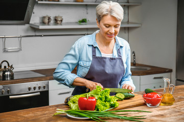 Mature woman cooking in kitchen