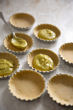 Tart shells with short crust pastry filled with pistachio frangipane