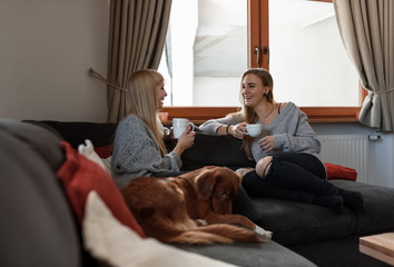 Happy chatting women with coffee
