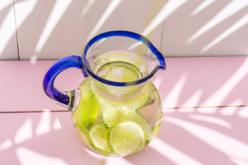 Lime water in glass jar on colorful background