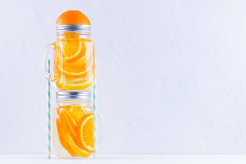 Infused water with fruits on white background. Mug delicious refreshing drink of mix fruits on white background. Iced summer drink in mason jar. Minimalism