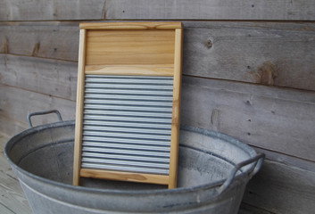 Wood and galvanized metal washboard in galvanized wash tub