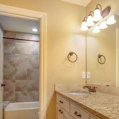 Square frame Bathroom interior with a double vanity unit and hanging racks on the wall