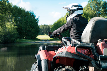 ATV in nature. Outdoor activity. Quad bike rides. Extreme sport. Forest, nature, river, field.