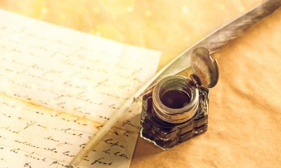 Feather pen into the inkwell. Isolated