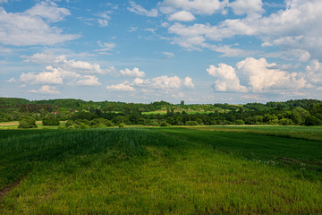 blue sky with white clouds over countryside landscape