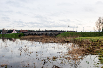 deep dark forest lake with reflections of trees and green foliage