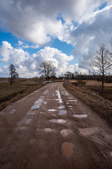 blue sky with white clouds over countryside landscape