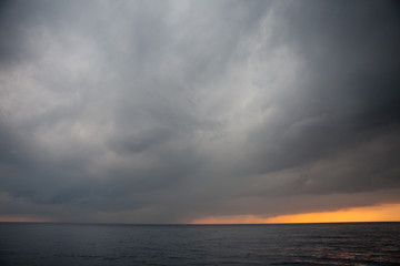 Storm clouds drift across the Pacific ocean in Komodo National Park, Indonesia. This tropical area is part of the Coral Triangle and is a popular destination for divers and snorkelers.