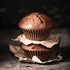 Sweet muffins with on dark textured background.