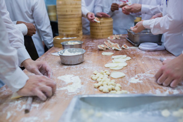 Dim Sum chefs working wrapping dumplings at famous restaurant in Taiwan.