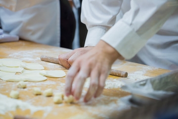 Dim Sum chefs working wrapping dumplings at famous restaurant in Taiwan.