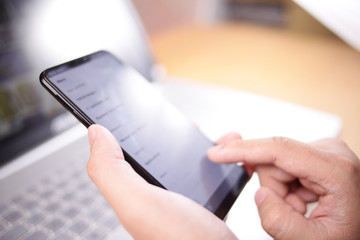 Businessman Holding and Using Smart Phone