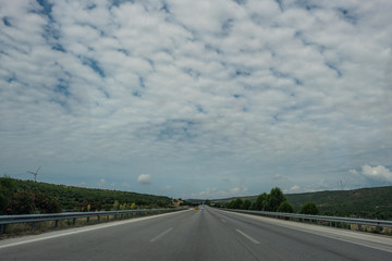 Three Lane Highway Road Under Cloudy Sky