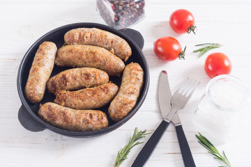 Grilled sausages with tomatoes , pepper and rosemary