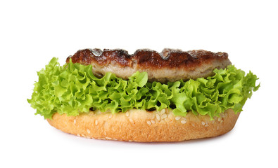 Burger bun with lettuce and cutlet isolated on white