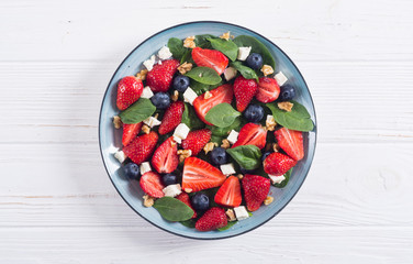 Summer Strawberry salad with spinach , cheese , nuts and blueberry