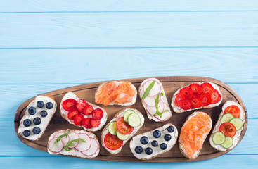 Variation of toast with fruit , vegetable and salmon