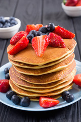 Tasty pancakes with blueberry and strawberry