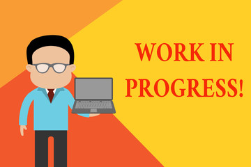 Handwriting text Work In Progress. Conceptual photo unfinished project that still added to or developed Standing man in suit wearing eyeglasses holding open laptop photo Art