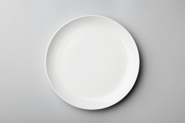 Clean empty plate on grey background, top view