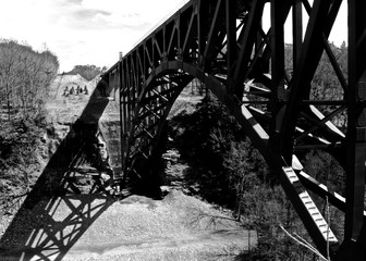 Old steel railroad bridge over valley black and white 