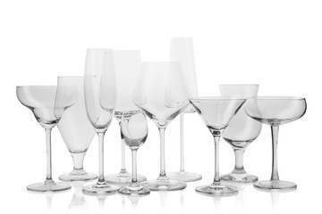 Set of empty glasses for different drinks on white background
