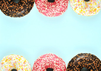 Delicious donuts on colorful background.