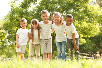Fototapeta premium Group of children huddling in park. Volunteer project