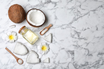 Flat lay composition with natural organic coconut oil on marble background. Space for text