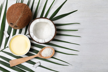 Flat lay composition with natural organic coconut oil on wooden background. Space for text