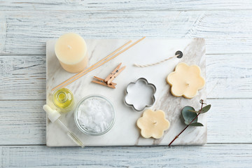 Flat lay composition with handmade candles on wooden background