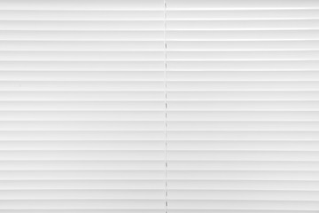 Fototapeta premium Window with closed white horizontal blinds as background