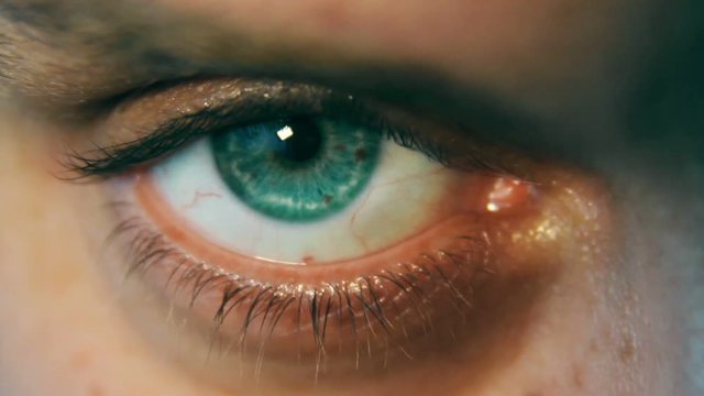 Woman's eye changing color when she blinks, close up shot
