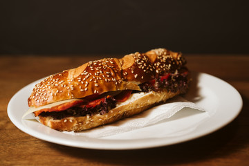 Sandwich with a kulen and a vegetable in a restaurant