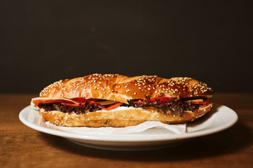 Sandwich with a kulen and a vegetable in a restaurant