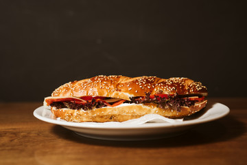 Sandwich with a kulen and a vegetable in a restaurant