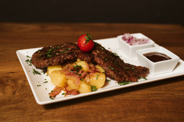 Steak with vegetables, potato and sauce  in the restaurant