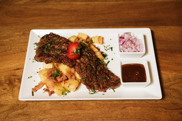 Steak with vegetables, potato and sauce  in the restaurant